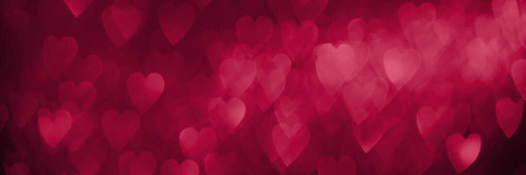 Trendy viva magenta, pink red hearts, sparkling glitter bokeh panoramic background banner, valentines day abstract defocused texture header. Color of the year 2023
