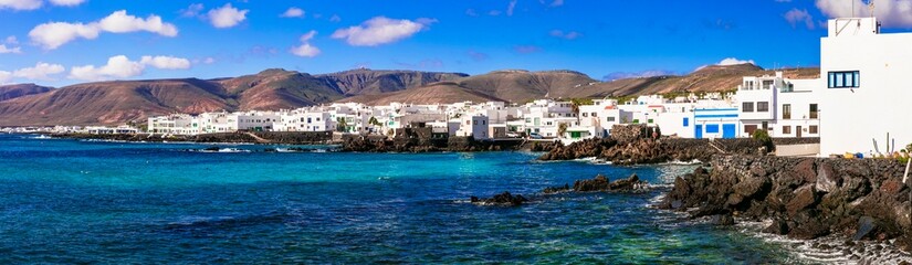 Canary islands .Lanzarote, view of scenic fishing village Punta Mujeres with white houses and crystal sea