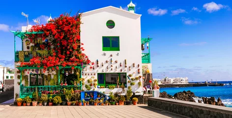 Poster Lanzarote scenic places. Charming  Punta Mujeres traditional fishing village with floral streets and white houses. popular  for natural swim pools. Canary islands travel © Freesurf