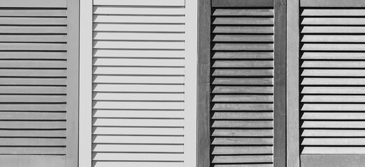 Part of modern interior with grey patterned texture of wooden black and white shutters, casements or blinds background