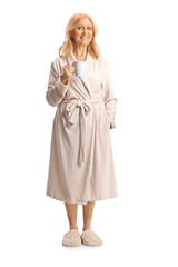 Full length portrait of a mature woman in a bathrobe holding a cup