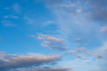 Beautiful sunset or sunrise sky, illuminating dark blue and pale pink clouds. Cloudy sky to overlay on your photos