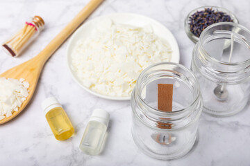Basic set for homemade natural white eco-friendly soy wax candles in glass, wick, perfume on white marble. Hobby, business. Making candles with your own hands.Vegan product. Copy space.