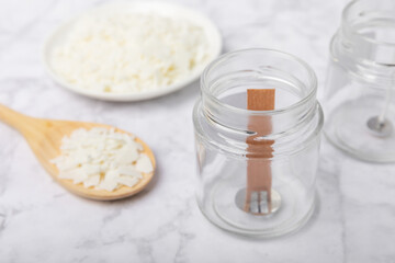 Basic set for homemade natural white eco-friendly soy wax candles in glass, wick, perfume on white marble. Hobby, business. Making candles with your own hands.Vegan product. Copy space.