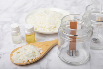 Basic set for homemade natural white eco-friendly soy wax candles in glass, wick, perfume on white marble. Hobby, business. Making candles with your own hands.Vegan product. Copy space.