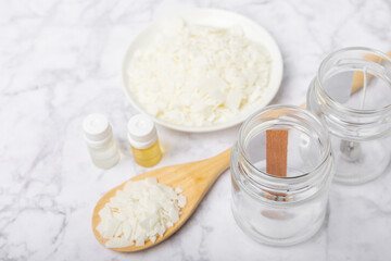 Basic set for homemade natural white eco-friendly soy wax candles in glass, wick, perfume on white marble. Hobby, business. Making candles with your own hands.Vegan product. Copy space.