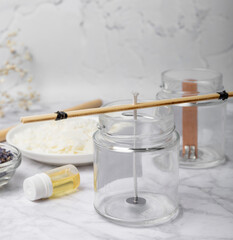 Basic set for homemade natural white eco-friendly soy wax candles in glass, wick, perfume on white marble. Hobby, business. Making candles with your own hands.Vegan product. Copy space.