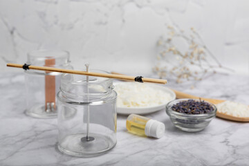 Basic set for homemade natural white eco-friendly soy wax candles in glass, wick, perfume on white marble. Hobby, business. Making candles with your own hands.Vegan product. Copy space.