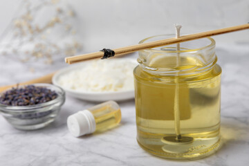 Basic set for homemade natural white eco-friendly soy wax candles in glass, wick, perfume on white marble. Hobby, business. Making candles with your own hands.Vegan product. Copy space.