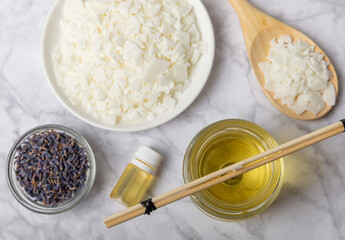 Basic set for homemade natural white eco-friendly soy wax candles in glass, wick, perfume on white marble. Hobby, business. Making candles with your own hands.Vegan product. Copy space.