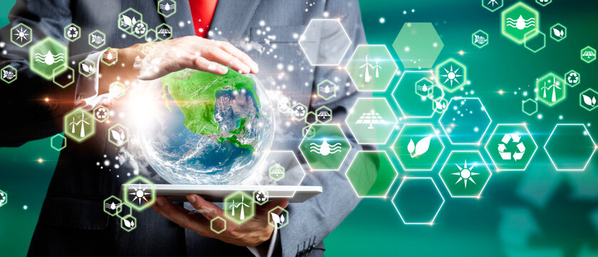 Businessman with tablet holding the green planet earth. Eco concept, ecology, clean energy and environment. Elements of this image furnished by NASA.