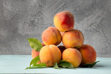 Naklejka na ściany i meble Fresh peaches on a gray background.