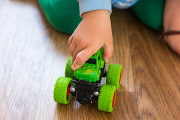 Kid's hand holding a toy car close-up