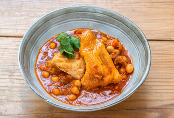 Chicken stew with chickpeas in close-up, traditional Portuguese Mediterranean dish.