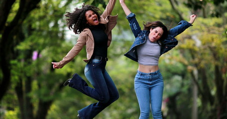 Happy diverse women jump in the air in celebration