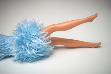 Closeup of mannequin doll legs with a blue woolen dress on white background - 551894868
