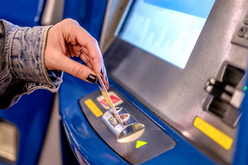 Close up picture of woman that top up credit in a travel pass in public transport