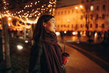Happy woman at the Christmas market at night