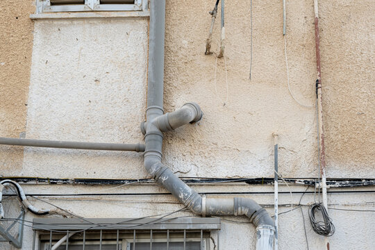 Plumbing installation of water pipe and sewerage system on the building exterior wall in israel