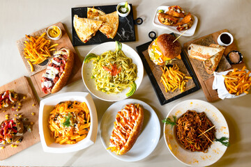 Traditional Turkish cuisine. Pizza, pita, pidesi, sucuk, hummus, kebab. Many dishes on the table. Serving dishes in restaurant. Background image. Top view, flat lay