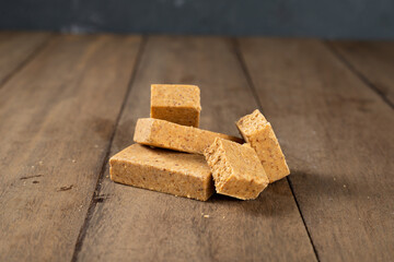 Stack of Brazilian Peanut Sweet called paçoca on a wooden desk