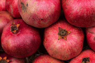 Background from ripe pomegranates that are on the vegetable market