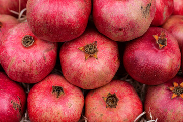 Background from ripe pomegranates that are on the vegetable market