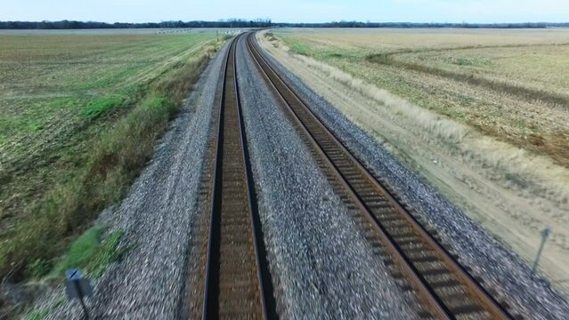 Aerial flying down the train tracks in the fall.