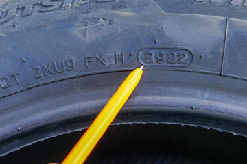 Side view of tire with designation of week and year of tire production, tire marking
