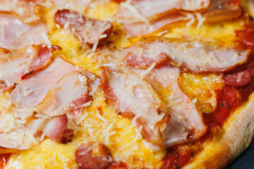 Delicious freshly baked pizza with tomato sauce and meat and cheese filling.