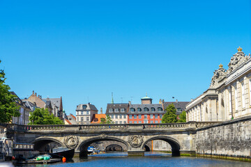 Obraz premium Bridge with bas-relief in Copenhagen, Denmark. Decor elements of bridge in Copenhagen. City decorations. River boat tour