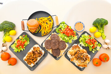 Traditional Turkish cuisine. Pizza, pita, pidesi, sucuk, hummus, kebab. Many dishes on the table. Serving dishes in restaurant. Background image. Top view, flat lay