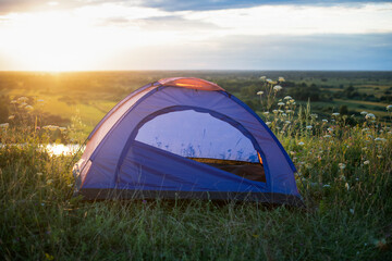 Tourist tent on mountain landscape at sunset in summer. Tourism Adventure travel lifestyle concept.