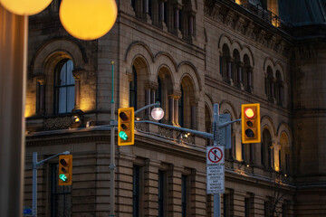 Traffic lights against historical building in downtown Ottawa, Canada at night - obrazy, fototapety, plakaty