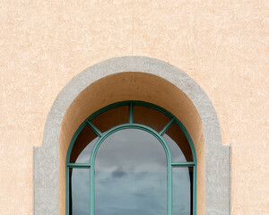 Arch window on stucco wall
