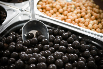 Assorted chocolate pralines arranged in metal boxes for sale