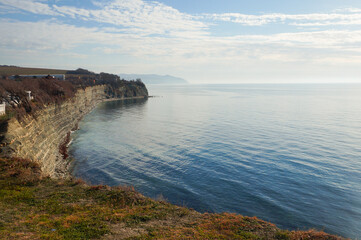 Obraz premium view from the cliff to the sea bay and beautiful clouds