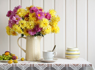 bouquet of chrysanthemums, plums and grapes, garden flowers in a jug and berries. Cottage core.