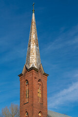 The steeple of St. Andrew’s Lutheran Church in Aksi (Estonian - Äksi), Tartu County on a sunny spring day.