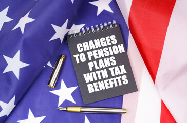 On the American flag lies a pen and a notebook with the inscription - changes to pension plans with tax benefits
