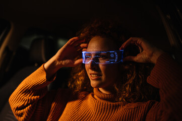 Smiling woman with glowing smart glasses on the street. Close up.