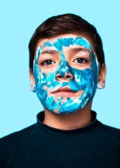 Funny children portrait  with face painting on color background