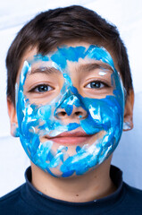 Funny children portrait  with face painting on color background