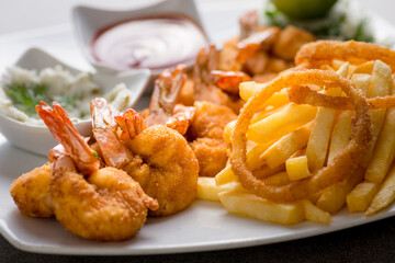 shrimps bani or fried shrimp with fries and tomato sauce served in dish isolated on grey background top view of arabic food