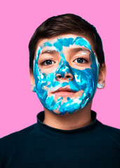 Funny children portrait  with face painting on color background