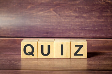 quiz word made with wooden blocks and brown background