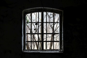 Obraz premium Window without glass in dark abandoned building.