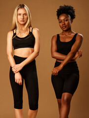 Two girls posing in studio. Diversity concept. Beauty photography.