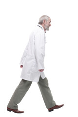 elderly competent doctor striding forward. isolated on a white