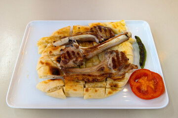 Beef steak grill with rice pilaf, fried potatoes, grilled pepper and tomatoes.Mix Platter with Beef rips, Cutlets, Potatoes and Sauces.